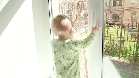 The child looks out the window Stock Footage 130348982