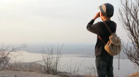 Child looks through binocular Stock Footage 11484599