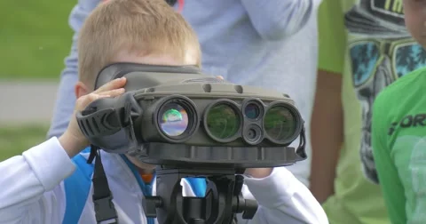 A Child Looks Through Binoculars in Camera. Stock Footage 62794223