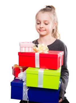 Child with a lot of gift boxes in hands on isolated background Foto stock