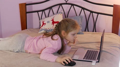 Child Lying On A Bed And Using Laptop Computer Stock Footage 73271073