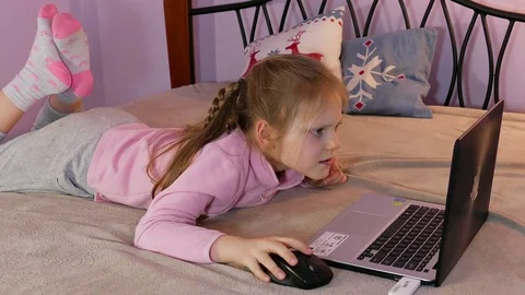 Child Lying On A Bed And Using Laptop Computer 002 Stock Footage 73889732
