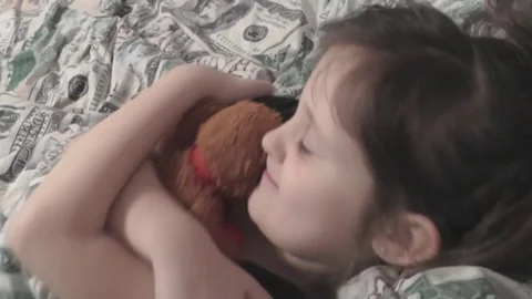 The Child is Lying in Bed, Hugging Teddy Bear Stock Footage 72613826