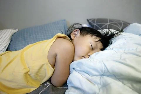 Child Lying On The Bed Stock Photos