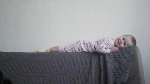The child is lying on the couch Stock Footage 270070614