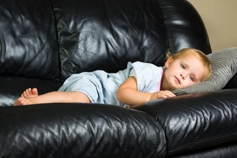 Child lying on the couch Stock Photos