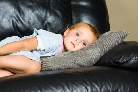 Child lying on the couch Stock Photos