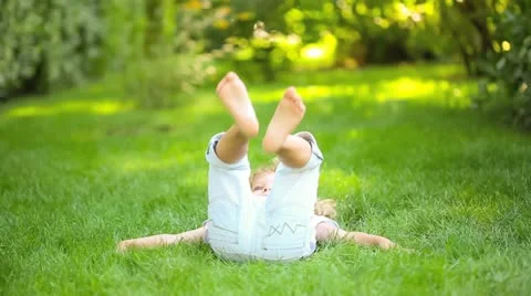 Child lying on grass Stock Footage 20029908