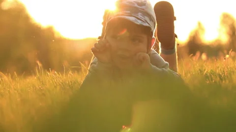 Child is lying on the grass Stock Footage 50655289