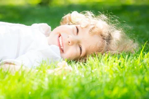 Child lying on grass Stock Photos