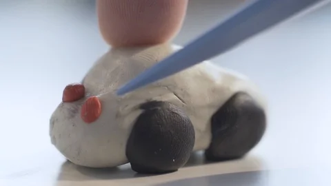 A child makes a car door with a plasticine knife Stock Footage 124208736
