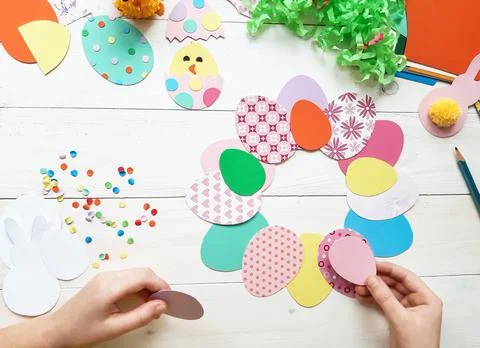 The child makes crafts with his own hands for the Easter. Stock Photos