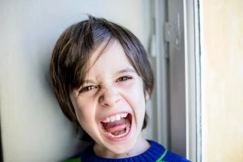 Child makes grimaces Stock Photos