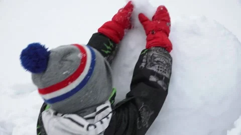 The child makes a snowman Stock Footage 149180269
