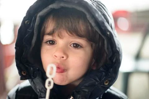 Child makes soap bubbles in winter Stock Photos