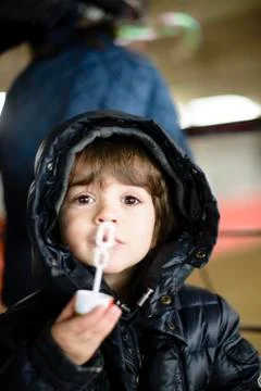 Child makes soap bubbles in winter Stock Photos