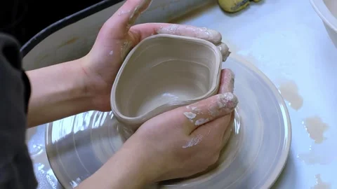 Child making ceramic vase on rotating pottery wheel at workshop. Creativity. Stock Footage 304456777