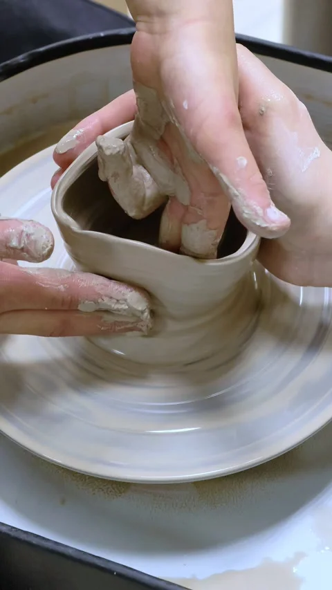 Child making ceramic vase on rotating pottery wheel at workshop. Creativity. Stock Footage 304550462