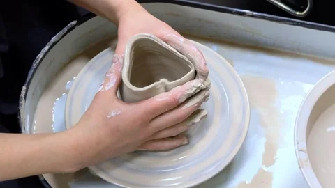 Child making ceramic vase on rotating pottery wheel at workshop. Creativity. Stock Footage 304595773