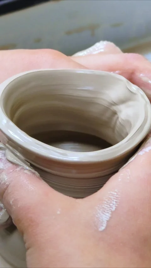 Child making ceramic vase on rotating pottery wheel at workshop. Creativity. Stock Footage 304954721