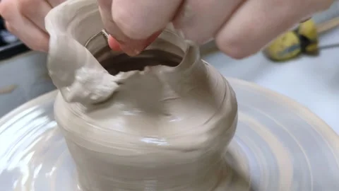 Child making ceramic vase on rotating pottery wheel at workshop. Creativity. Stock Footage 304955445