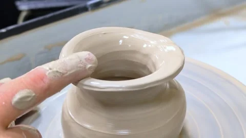 Child making ceramic vase on rotating pottery wheel at workshop. Creativity. Stock Footage 305028119