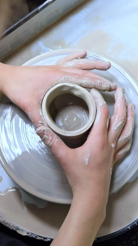 Child making ceramic vase on rotating pottery wheel at workshop. Creativity. Stock Footage 305150677