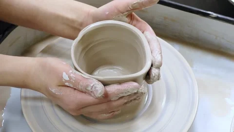 Child making ceramic vase on rotating pottery wheel at workshop. Creativity. Stock Footage 305504917