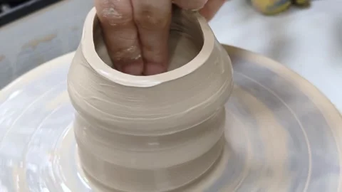 Child making ceramic vase on rotating pottery wheel at workshop. Creativity. Stock Footage 305551621