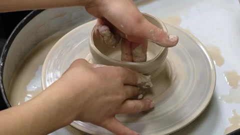 Child making ceramic vase on rotating pottery wheel at workshop. Creativity. Stock Footage 305861179
