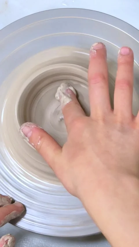 Child making ceramic vase on rotating pottery wheel at workshop. Video stock 324725397