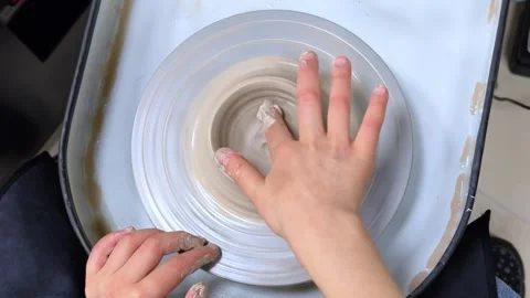 Child making ceramic vase on rotating pottery wheel at workshop. Creativity. Stock-Footage 324726217