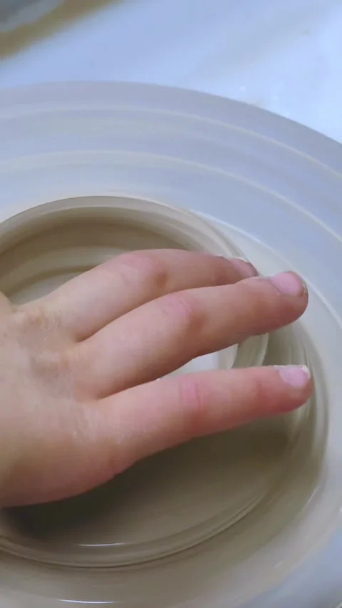 Child making ceramic vase on rotating pottery wheel at workshop. Creativity. Stock-Footage 325020975
