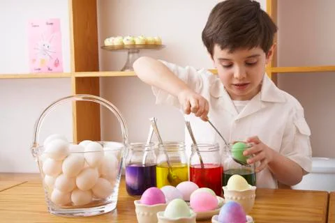 Child Making Easter Eggs Stock Photos