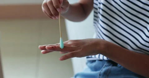 Child making first aid and putting medicine on wound by herself. Stock Footage 288844083