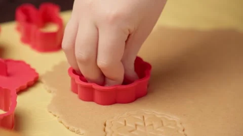 Child making gingerbread cookies using various forms. Christmas and New Year Stock Footage 290375908