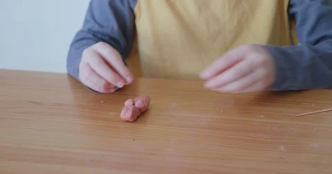 Child making handmade art from modeling clay Stock-Footage 128218907