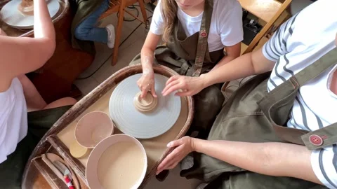 Child making a handmade clay pot in the workshop. Pottery lesson with master.  Stock Footage 277790279