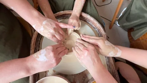 Child making a handmade clay pot in the workshop. Pottery lesson with master.  Stock Footage 277793701