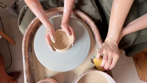 Child making a handmade clay pot in the workshop. Pottery lesson with master.  Stock Footage 277794461