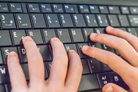 Child making homework on keyboard computer pc Foto stock