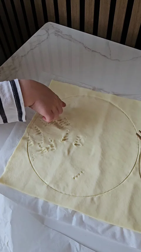 Child Making Patterns on Dough with Fork Stock Footage 304791095