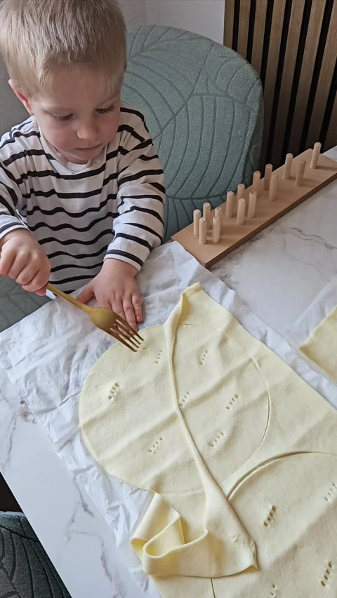 Child Making Patterns on Dough with Fork Stock Footage 306836795