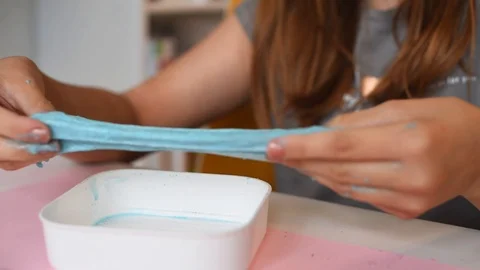 Child making slime - step by step guide. playing with slime. Stock Footage 111892692