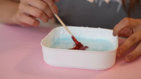 Child making slime - step by step guide. playing with slime. Stock Footage 111892914