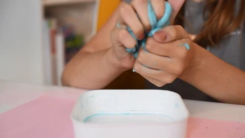 Child making slime - step by step guide. playing with slime. Stock Footage 111892931