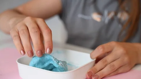 Child making slime - step by step guide. playing with slime. Stock Footage 111893004
