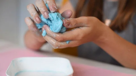 Child making slime - step by step guide. playing with slime. Stock Footage 111893023