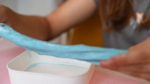 Child making slime - step by step guide. playing with slime. Stock Footage 111893074