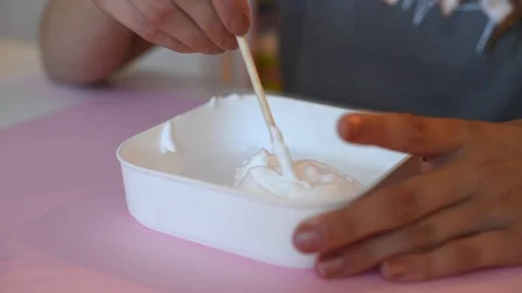 Child making slime - step by step guide. playing with slime. Stock Footage 111893246